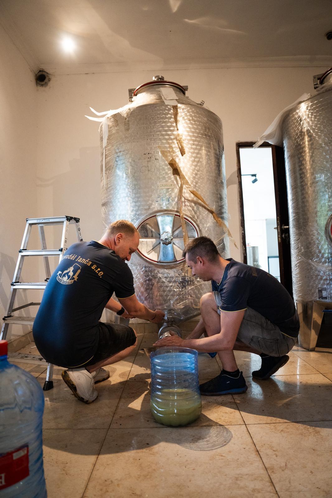 Czech technicians commissioning a stainless-steel fermentation tank